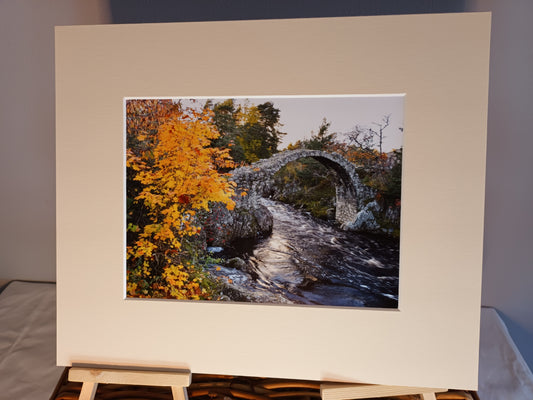 Autumn view of the Old Pack Horse Bridge at Carrbridge window mounted print