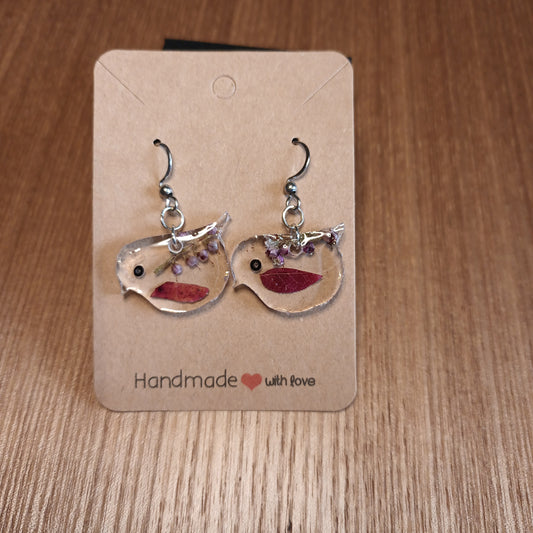 Pair of earrings on a 'Handmade with Love' card on a wooden surface  robin 